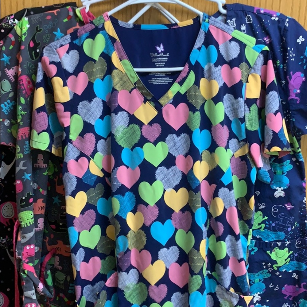 Four scrub tops